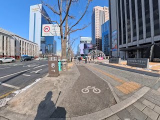 Shared pedestrian and bicycle sidewalk in central Seoul with clear lane markings