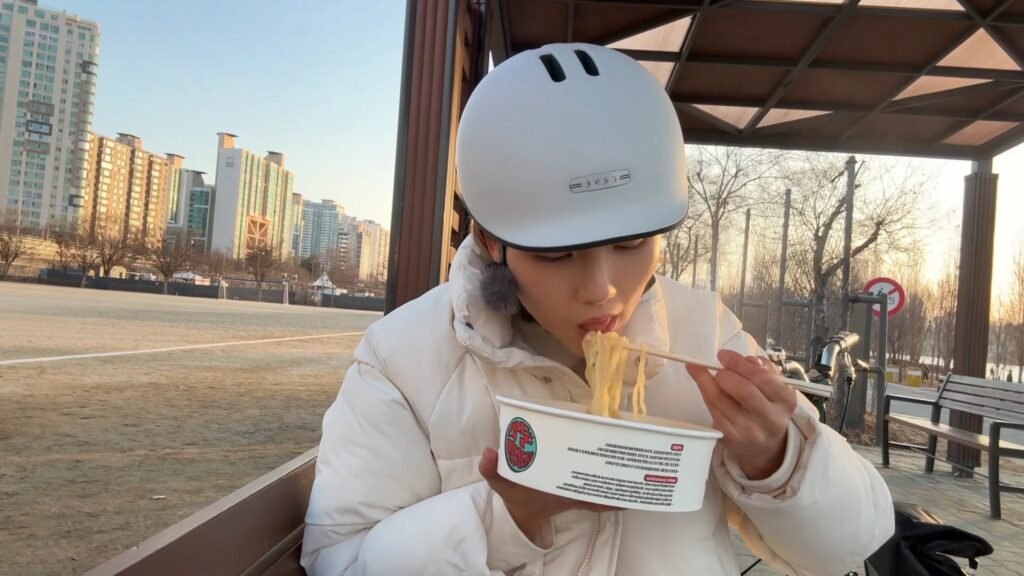 Enjoying Han River ramen on a park bench like a local